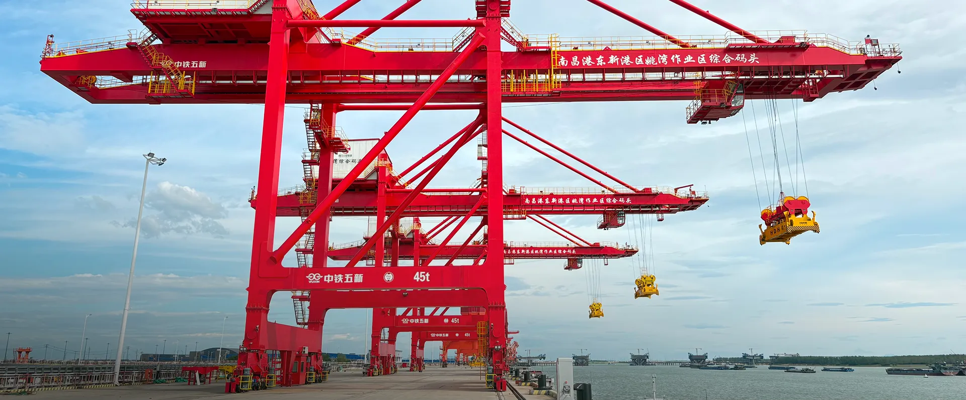 Port terminal with red portal cranes beside the sea for integrated terminals